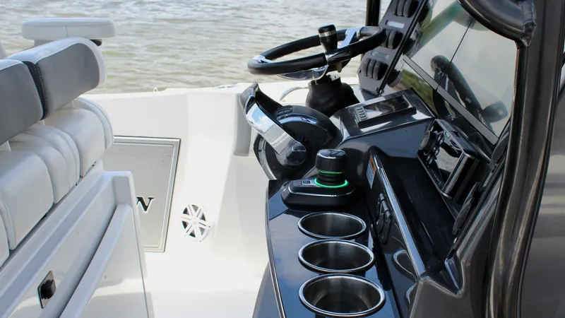 Slide: The Image of Helm Station with Seating Area The helm station of the 2020 Blackfin 332 Center Console showcases a sleek, modern design with state-of-the-art controls and a polished steering wheel. The console is equipped with multiple cup holders and advanced navigation screens, ensuring a comfortab - 6687435