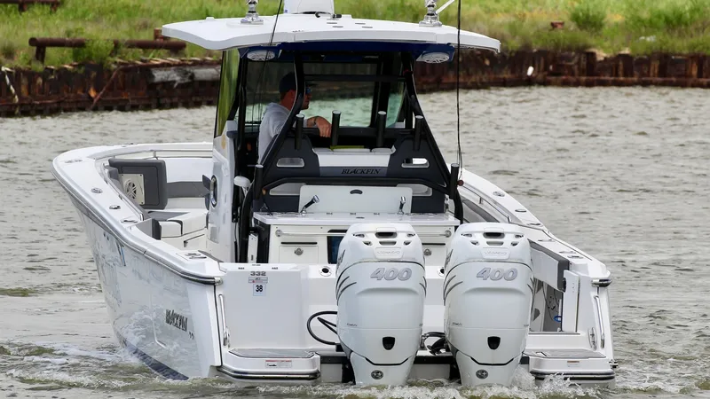Slide: The Image of Aft View with Dual Engines This image showcases the sleek aft section of the 2020 Blackfin 332 Center Console, featuring powerful dual 400 horsepower engines. The open deck layout is designed for both functionality and comfort, ideal for serious fishing or leisurely outings. The st - 6687452