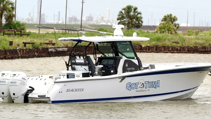 Slide: The Image of Side View of Center Console This image showcases the sleek side profile of the 2020 Blackfin 332 Center Console, named 'Got Tuna'. The vessel features a robust T-top providing shade and protection, along with ample rod holders for fishing enthusiasts. The clean lines and modern desi - 6687451