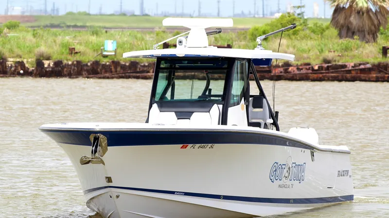 The Image of Bow View of Blackfin 332 Center Console The 2020 Blackfin 332 Center Console, named 'Got Tuna,' showcases its sleek and powerful bow design, perfect for cutting through waves with ease. The vessel features a sturdy T-top and a spacious console, ensuring comfort and protection on open waters. It - 6687430