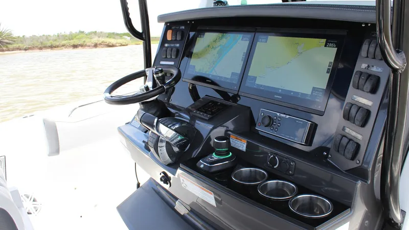 Slide: The Image of Helm Station with Dual Displays The helm station of the 2020 Blackfin 332 Center Console features dual high-resolution displays, providing seamless navigation and system control. The ergonomic design includes a sleek steering wheel and intuitive joystick, enhancing maneuverability. Stai - 6687436