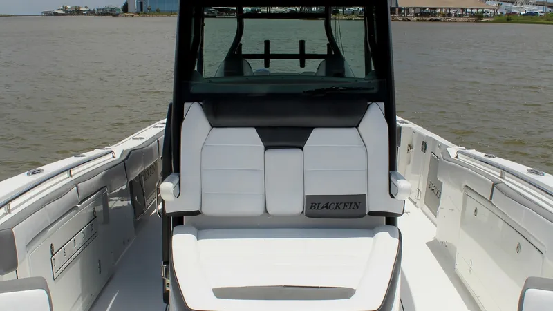 Slide: The Image of Bow Seating Area with Helm View The image showcases the elegant bow seating area of the Blackfin 332 Center Console. The plush, white upholstery offers comfort and style, complemented by the sleek design of the helm station. This spacious area provides an inviting space for relaxation w - 6687444