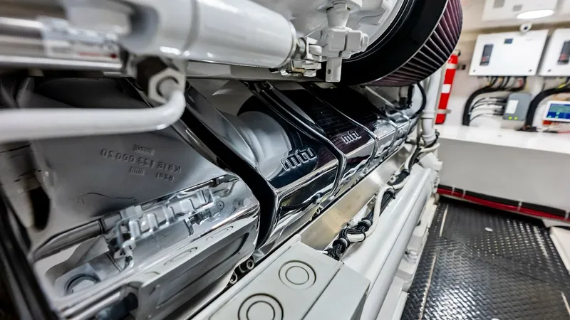 Slide: The Image of Engine Room with Powerful Engines This image showcases the immaculate engine room of the 2018 Viking 62 Convertible, 'Rollin' Deep.' The room features powerful, high-performance engines encased in sleek, polished metallic covers. The pristine environment and organized layout highlight the - 8440091