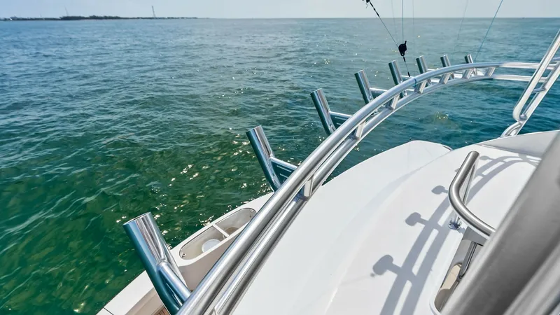 Slide: The Image of Stern View with Rod Holders This image showcases the stern of the 2018 Viking 62 Convertible, featuring a sleek arrangement of stainless steel rod holders. The wide-open view of the ocean highlights the vessel's suitability for sportfishing, while the sturdy construction promises du - 8440083