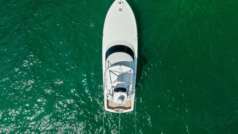 Slide: The Image of Aerial View of Flybridge and Bow This aerial shot showcases the sleek design of the 2018 Viking 62 Convertible, Rollin' Deep. The image highlights the streamlined flybridge with its commanding helm station and the spacious bow area, perfect for sunbathing or enjoying ocean views. The ves - 8440111