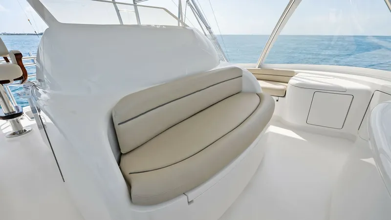 Slide: The Image of Flybridge Helm Seating This image showcases the luxurious flybridge helm seating on the 2018 Viking 62 Convertible. The plush, cushioned seat offers comfort and a commanding view of the open sea. The sleek, modern design is complemented by high-quality materials, making it an i - 8440081