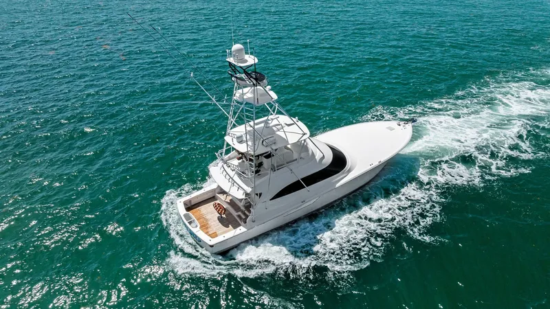 Slide: The Image of Aerial View of Flybridge and Deck This aerial shot showcases the Viking 62 Convertible's sleek flybridge and spacious aft deck. The well-equipped flybridge offers excellent visibility, perfect for navigating open waters, while the teak-accented aft deck provides ample space for relaxation - 8440119