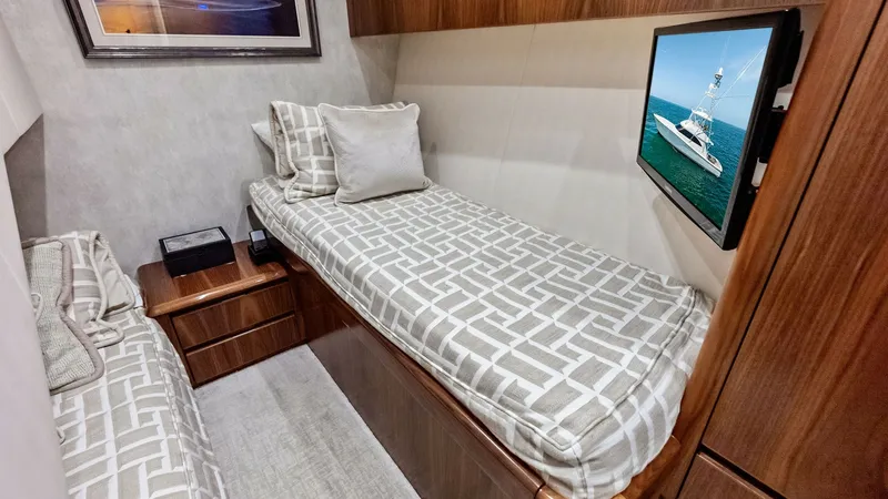 Slide: The Image of Guest Cabin with Twin Berths This inviting guest cabin features comfortable twin berths with stylish patterned bedding, offering a cozy retreat for guests. The warm wood finishes and elegant cabinetry enhance the room's sophisticated ambiance. A mounted flat-screen TV provides entert - 8440062