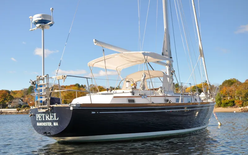 Slide: The Image of 1984 Bristol 41.1 | Petrel Sailing yacht anchored in scenic waters with clear skies. - 6523038