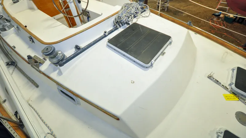 Slide: The Image of 1984 Bristol 41.1 | Petrel Yacht deck with winch, ropes, and hatch. - 6523072