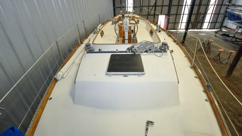 Slide: The Image of 1984 Bristol 41.1 | Petrel Sailboat deck in storage, featuring ropes and winches. - 6523042