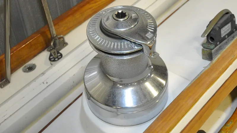 Slide: The Image of 1984 Bristol 41.1 | Petrel Chrome winch on a 1984 Bristol 41.1 sailboat deck, featuring wooden trim. - 6523065