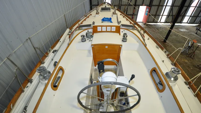 Slide: The Image of 1984 Bristol 41.1 | Petrel The deck of a 1984 Bristol 41.1 with a steering wheel and winches. - 6523067