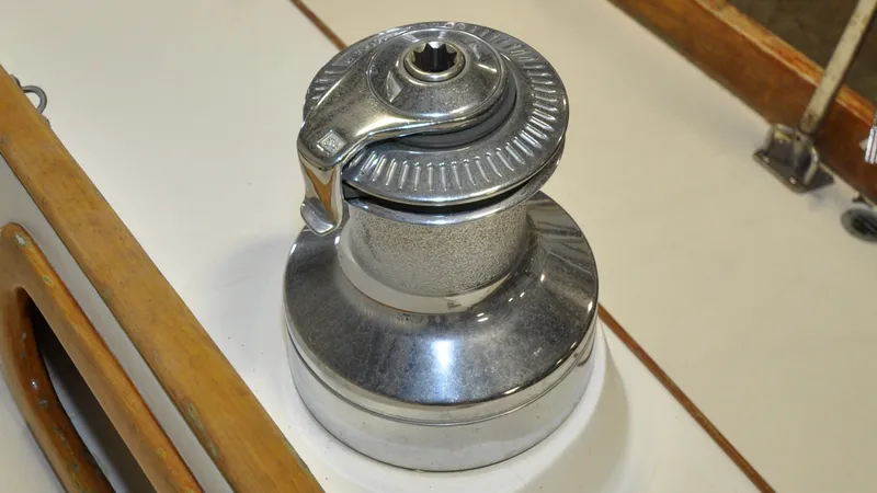 Slide: The Image of 1984 Bristol 41.1 | Petrel Winch mechanism on a 1984 Bristol 41.1 sailboat deck, featuring metal and wood components. - 6523066