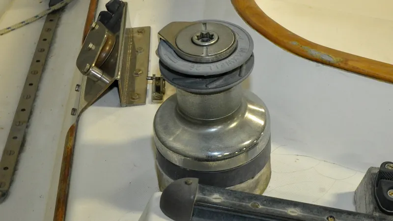 Slide: The Image of 1984 Bristol 41.1 | Petrel Winch mechanism on a 1984 Bristol 41.1 sailboat deck, featuring metal and wood components. - 6523068