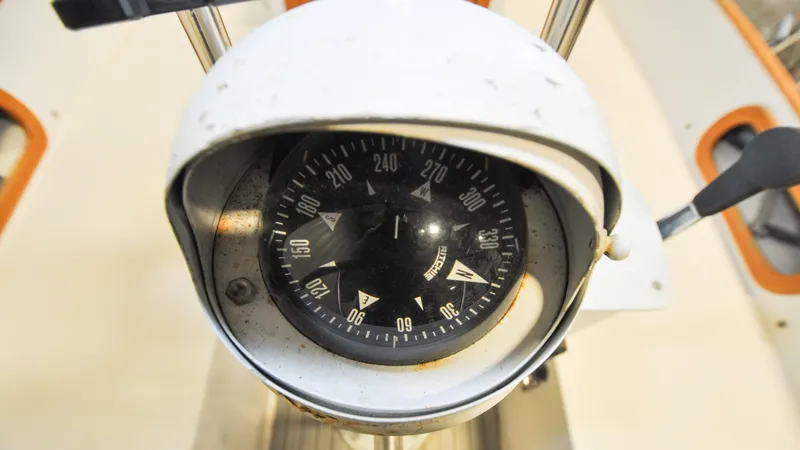 Slide: The Image of 1984 Bristol 41.1 | Petrel Compass, close-up view, showing directional markings and weathered casing. - 6523063