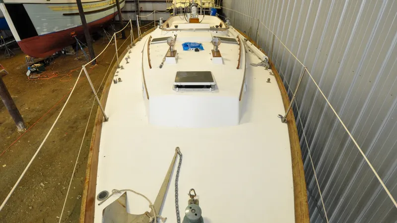 Slide: The Image of 1984 Bristol 41.1 | Petrel Sailboat in storage, viewed from above, showcasing deck and fittings. - 6523045