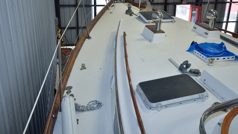 Slide: The Image of 1984 Bristol 41.1 | Petrel Sailboat deck in storage, featuring ropes and hatches. - 6523050