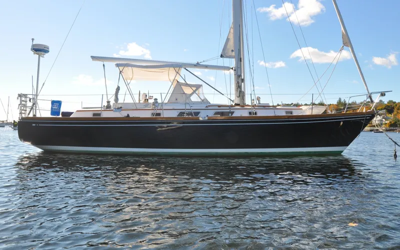 Slide: The Image of 1984 Bristol 41.1 | Petrel Sailboat on calm water under clear blue sky. - 6523035
