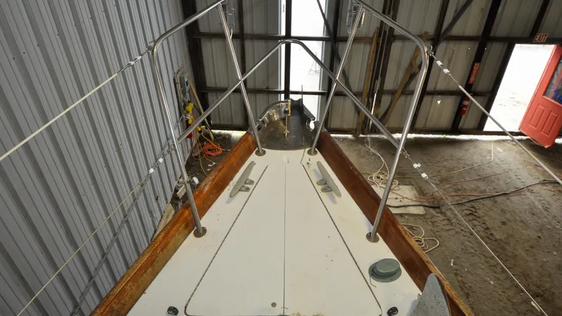 Slide: The Image of 1984 Bristol 41.1 | Petrel Sailboat deck with stainless steel railings in a storage facility. - 6523046