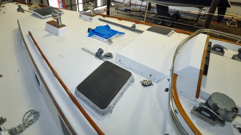 Slide: The Image of 1984 Bristol 41.1 | Petrel Yacht deck with hatches and fittings in a workshop setting. - 6523048