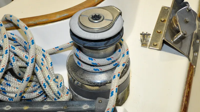 Slide: The Image of 1984 Bristol 41.1 | Petrel Sailboat winch with rope on a 1984 Bristol 41.1 yacht deck. - 6523069