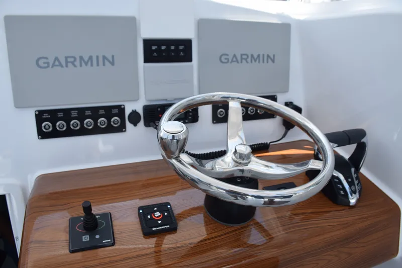 Slide: The Image of Helm Has Garmin Screens, Gyro Control Panel, Vhf, Thruster Jogstick, Seakeeper Ride Panel - 6551151