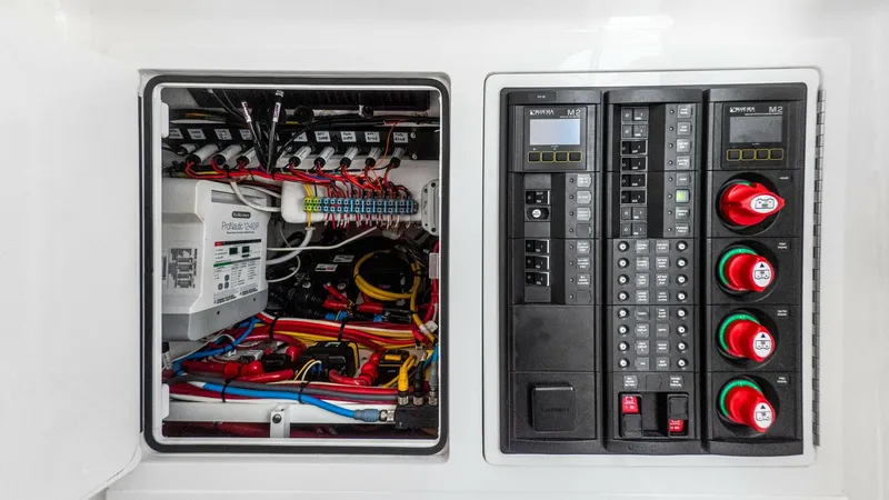 Slide: The Image of Electrical Control Panel and Wiring The image showcases the meticulously organized electrical control panel of the LONE STAR II, a 2022 Valhalla Boatworks V-37 model. Featuring a neatly arranged wiring system, the panel ensures optimal functionality and ease of maintenance. The modern switc - 6536775