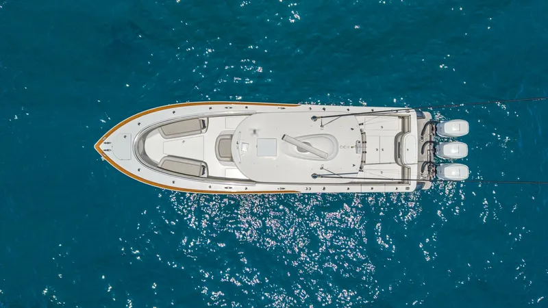 Slide: The Image of Aerial View of V-37 Deck Layout This aerial shot of the 2022 Valhalla V-37, LONE STAR II, showcases its sleek deck design. The spacious bow seating area and center console are complemented by a trio of powerful outboard engines, offering both comfort and performance. The clean lines and - 6536782
