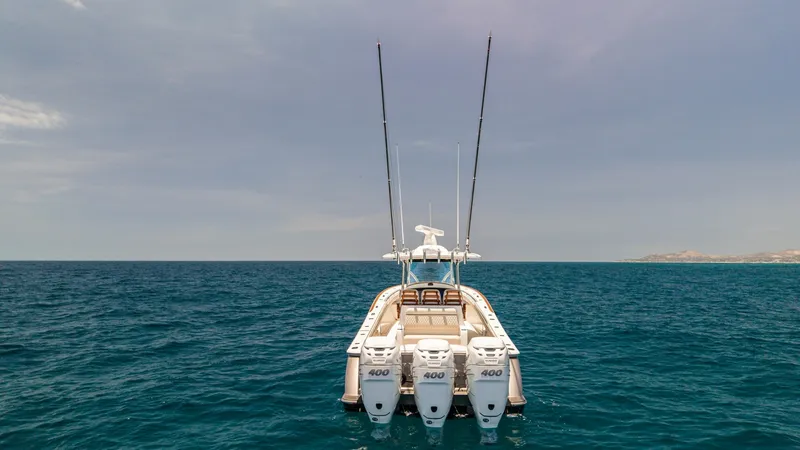 Slide: The Image of Aft View with Triple Outboards The LONE STAR II showcases an impressive aft view featuring triple 400 horsepower outboard engines, delivering exceptional performance and speed. The spacious deck is designed for both leisure and fishing, with ample seating and rod holders. This 2022 Val - 6536791