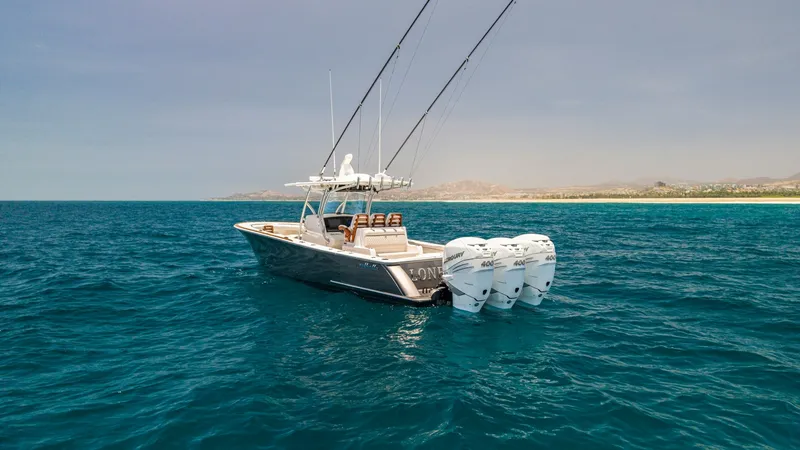 Slide: The Image of Aft View with Quad Outboards The Valhalla Boatworks V-37, LONE STAR II, showcases impressive power with its four robust outboard engines, designed for exceptional performance and speed. The sleek aft design is complemented by a spacious deck, offering ample seating for relaxation and - 6536790