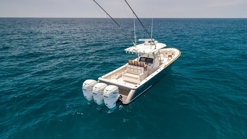 Slide: The Image of Aft Deck and Triple Outboards This image showcases the sleek aft deck of the LONE STAR II, a 2022 Valhalla V-37. Highlighted are the triple outboard engines, providing exceptional power and performance for offshore adventures. The spacious deck layout is designed for both relaxation a - 6536781