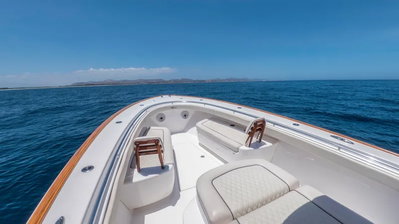 Slide: The Image of Elegant Bow Seating Area The bow of the LONE STAR II V-37 showcases luxurious seating with plush, diamond-stitched cushions, perfect for relaxation. The sleek teak accents along the gunwales add a touch of elegance and sophistication. Surrounded by stunning ocean views, this spac - 6536762