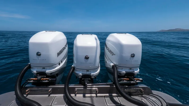 Slide: The Image of Triple Mercury Outboards on Aft Deck This image showcases the powerful triple Mercury outboards on the aft deck of the 2022 Valhalla V-37, LONE STAR II. These engines promise exceptional performance and reliability, ideal for both leisurely cruises and high-speed pursuits. The sleek design c - 6536778