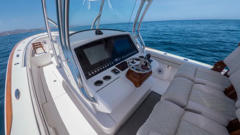 Slide: The Image of Helm Station with Seating Area The helm station of the 2022 Valhalla V-37, manufactured by Valhalla Boatworks, showcases a state-of-the-art navigation console with dual display screens and ergonomic controls. The area is complemented by plush, diamond-stitched seating, offering comfort - 6536768