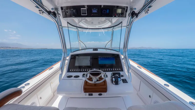 Slide: The Image of Helm Station with Panoramic View The helm station of the Valhalla Boatworks V-37 features a state-of-the-art dashboard with dual multifunction displays for seamless navigation. The luxurious teak steering wheel and ergonomic seating offer both comfort and control. Surrounded by clear vie - 6536764