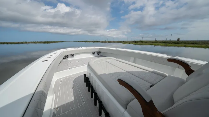 Slide: The Image of Spacious Bow Seating Area The bow of the 2023 Freeman 42 LR 'Fortunate Son' offers a luxurious seating area designed for comfort and relaxation. Featuring plush, cushioned seats with elegant armrests, this space invites you to unwind while enjoying panoramic views. The clean, mode - 6725109