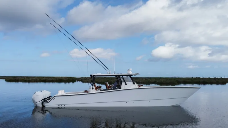 Slide: The Image of Profile View of Freeman 42 LR This image showcases the sleek profile of the 2023 Freeman 42 LR, highlighting its modern design and powerful outboard engines. The vessel's clean lines and spacious deck are evident, designed for both performance and comfort on the water. The T-top provi - 6725116