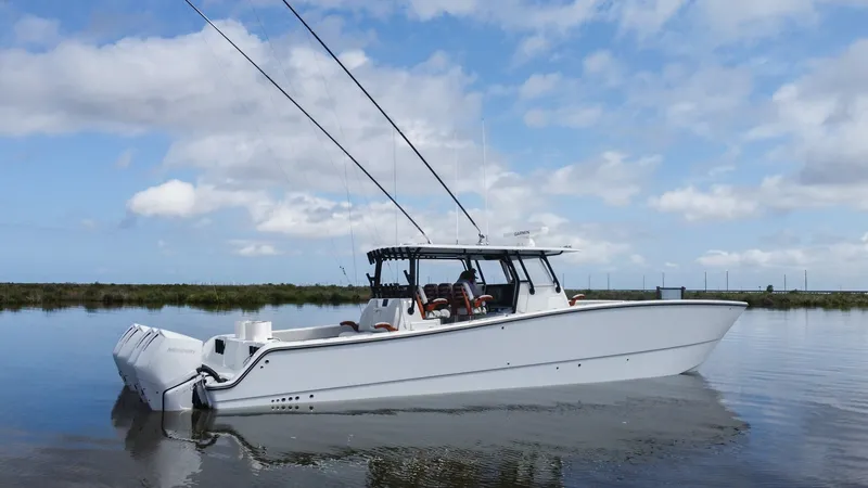 Slide: The Image of Side Profile of Freeman 42 LR The 2023 Freeman 42 LR, named Fortunate Son, showcases a sleek side profile with its modern, aerodynamic lines. Its spacious deck and robust hull design are complemented by a premium T-top, providing both style and protection. This vessel is equipped with - 6725125