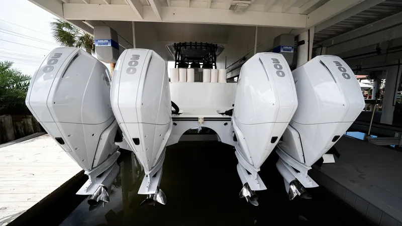 Slide: The Image of Quad Outboard Engines on Transom The Freeman 42 LR features four robust outboard engines mounted on the transom, showcasing the vessel's impressive power and performance capabilities. These engines are neatly aligned, ensuring optimal efficiency and speed for offshore adventures. The sle - 6725115