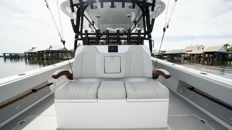 Slide: The Image of Center Console Seating Area The center console of the 2023 Freeman 42 LR features a plush seating area with premium quilted upholstery, providing comfort and style. The ergonomic design includes armrests and built-in storage, offering practicality for long voyages. Surrounded by a s - 6725102