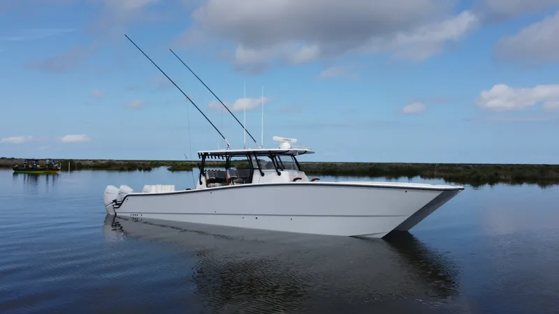 Slide: The Image of Port Side View of Freeman 42 LR This image showcases the sleek and modern design of the 2023 Freeman 42 LR, known for its superior performance on the water. The vessel features a streamlined hull and spacious deck, perfect for both leisure cruising and serious fishing. With its twin out - 6725120