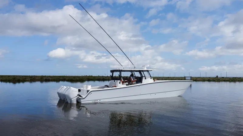 Slide: The Image of Side Profile on Calm Waters The 2023 Freeman 42 LR 'Fortunate Son' is showcased gracefully gliding on serene waters. This side profile highlights the sleek, aerodynamic design and robust build of the vessel, ideal for both fishing and leisure. The elegant lines and modern hull refle - 6725123