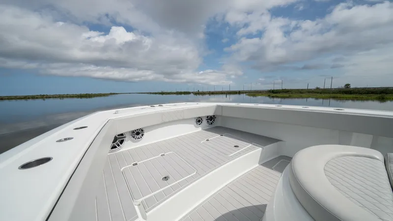 Slide: The Image of Spacious Bow Seating Area The bow of the 2023 Freeman 42 LR features a spacious seating area with sleek, cushioned benches, perfect for relaxing while enjoying panoramic views. The light gray decking complements the modern aesthetic, while integrated speakers provide high-quality - 6725110
