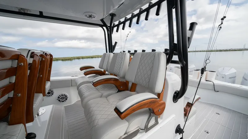 Slide: The Image of Cockpit Seating and Helm Area This image showcases the luxurious cockpit seating on the Freeman 42 LR. The plush, quilted seats with elegant wooden armrests offer both comfort and style, perfect for long voyages. The open design provides excellent visibility and access to the helm, ma - 6725105