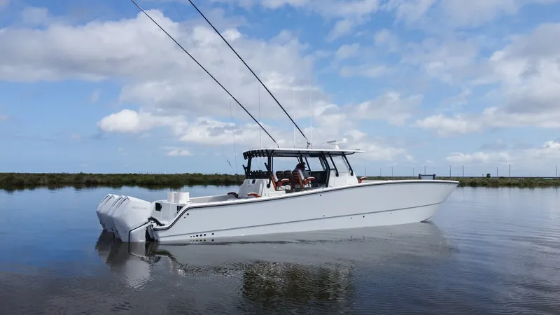 Slide: The Image of Starboard Profile of Freeman 42 LR The Freeman 42 LR showcases a sleek starboard profile, emphasizing its modern design and powerful stance. Equipped with dual outboard engines, this vessel promises high performance and agility on the water. The spacious center console and ample seating pr - 6725124