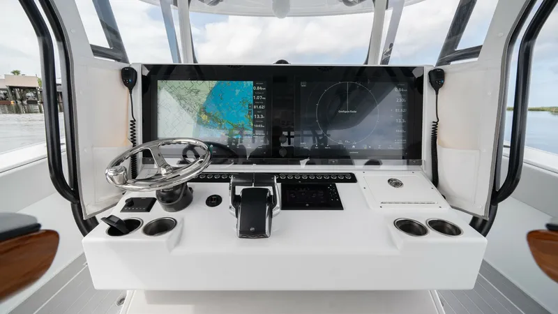 Slide: The Image of Helm Station with Advanced Electronics The helm station of the Freeman 42 LR features a sleek, modern design with an expansive multi-function display for navigation and system control. The stainless steel steering wheel and intuitive throttle controls ensure effortless handling. Ergonomic layo - 6725108