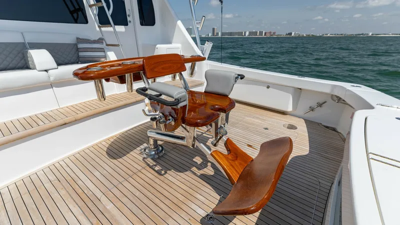 Slide: The Image of Spacious Teak Cockpit with Fighting Chair The cockpit of the 2020 Viking 62 Convertible features a beautifully crafted teak deck, offering ample space for serious anglers. At the center, a high-quality fighting chair is installed, designed for optimal performance and comfort during fishing excurs - 6711698