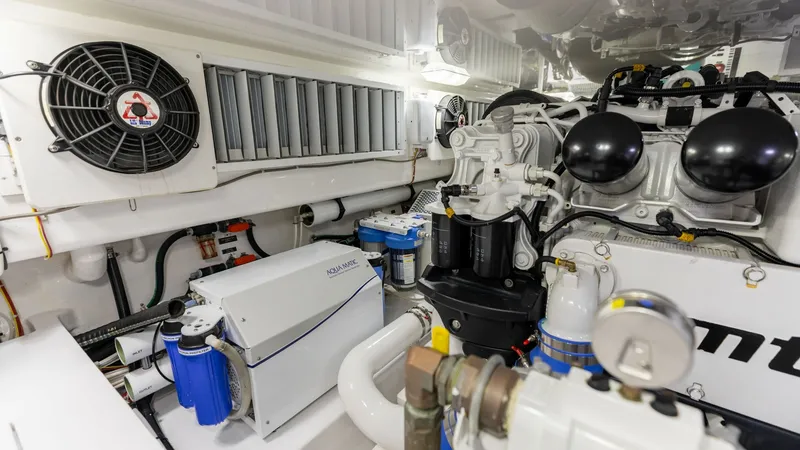 Slide: The Image of Engine Room with Advanced Systems The engine room of the 2020 Viking 62 Convertible showcases state-of-the-art engineering and meticulous design. Highlighted are advanced filtration systems and robust engine components, ensuring optimal performance and reliability. The space is efficientl - 6711706