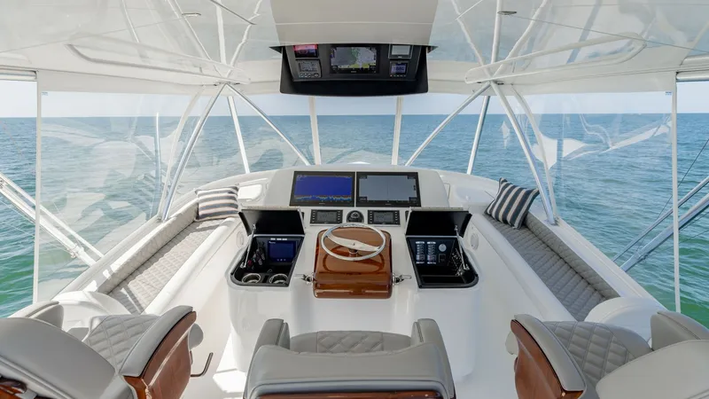 Slide: The Image of Flybridge Helm Station with Seating Experience the ultimate in command and comfort from the flybridge helm station of the 2020 Viking 62 Convertible. This area features a sophisticated layout with state-of-the-art navigation systems and dual captain's chairs crafted with premium materials. - 6711662